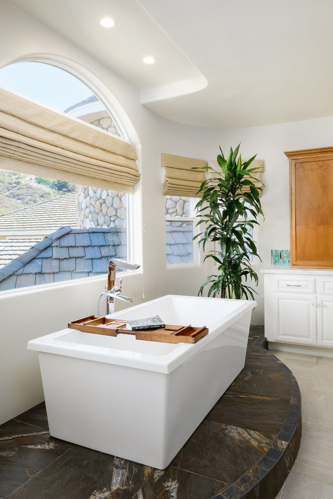 Large beach style master blue tile and glass tile porcelain tile and beige floor bathroom photo in San Diego with raised-panel cabinets, white cabinets, a one-piece toilet, white walls, an undermount sink, quartz countertops and white countertops