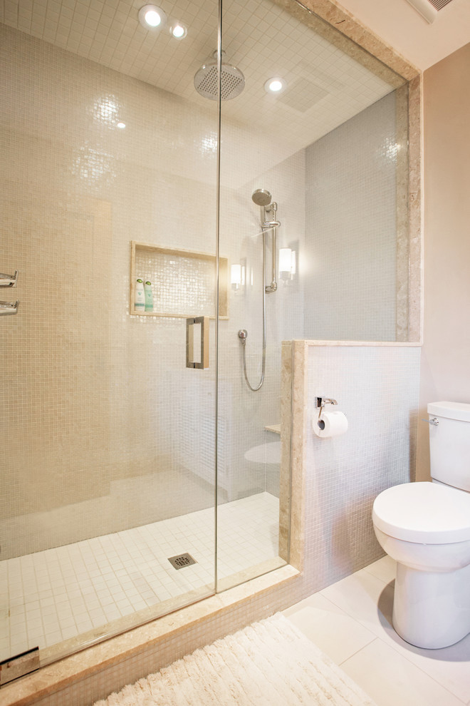 Bild på ett litet maritimt badrum med dusch, med ett undermonterad handfat, marmorbänkskiva, en dusch i en alkov, en toalettstol med separat cisternkåpa, beige kakel, porslinskakel, beige väggar och klinkergolv i porslin