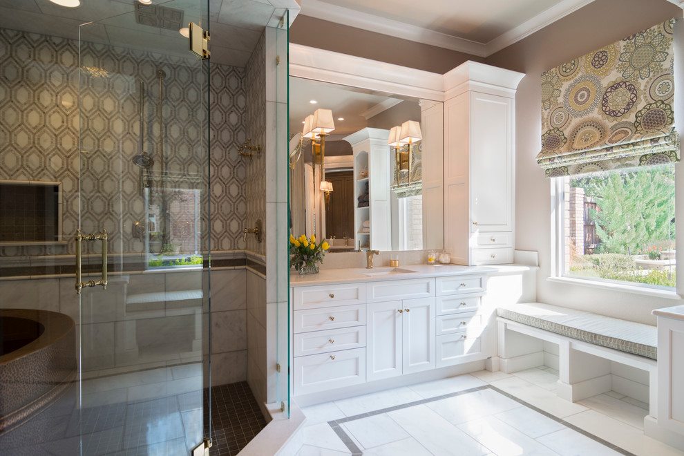 Example of a large classic master multicolored tile and stone tile marble floor bathroom design in Dallas with white cabinets, shaker cabinets, a two-piece toilet, beige walls, an undermount sink and marble countertops