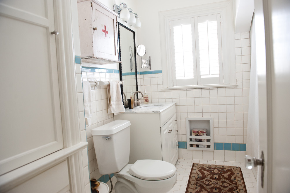Exemple d'une salle de bain éclectique avec un lavabo encastré, des portes de placard blanches et un carrelage blanc.