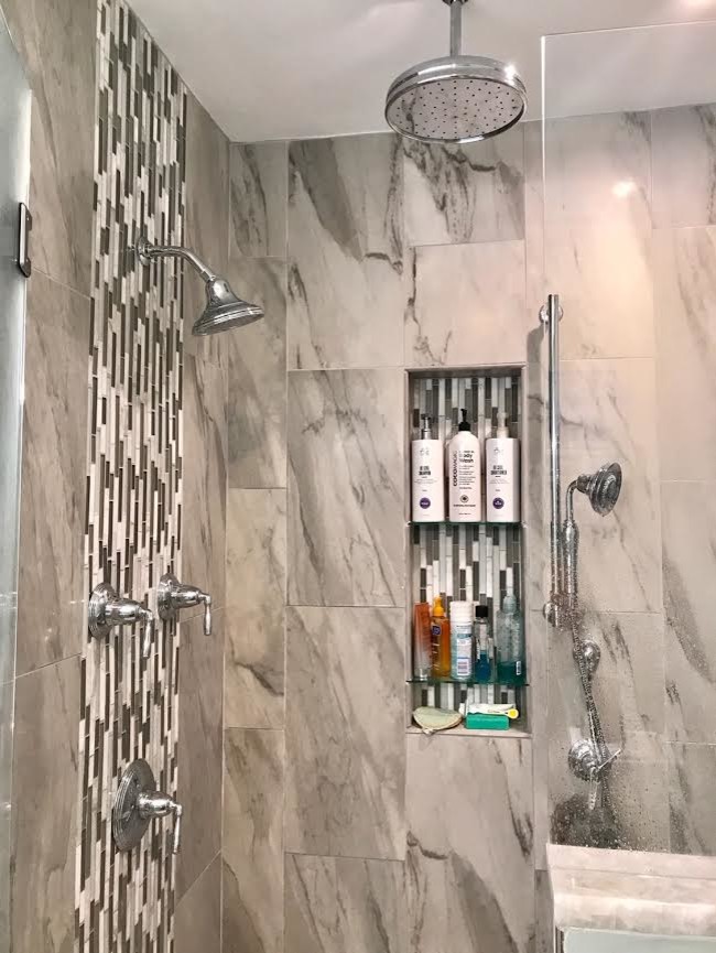 Large trendy master gray tile and porcelain tile medium tone wood floor and brown floor alcove shower photo in Detroit with shaker cabinets, white cabinets, a two-piece toilet, gray walls, a drop-in sink, marble countertops, a hinged shower door and gray countertops