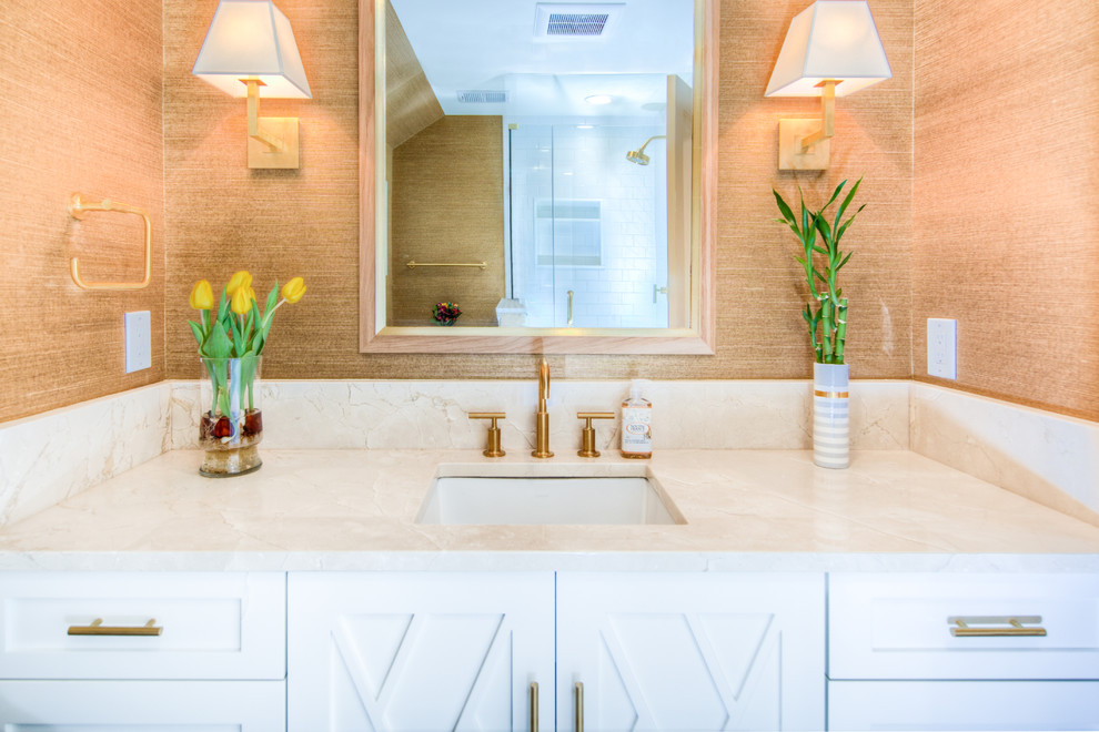 Large contemporary shower room bathroom in Philadelphia with shaker cabinets, white cabinets, a corner shower, a two-piece toilet, white tiles, metro tiles, brown walls, porcelain flooring, a submerged sink, marble worktops, beige floors, a hinged door and beige worktops.