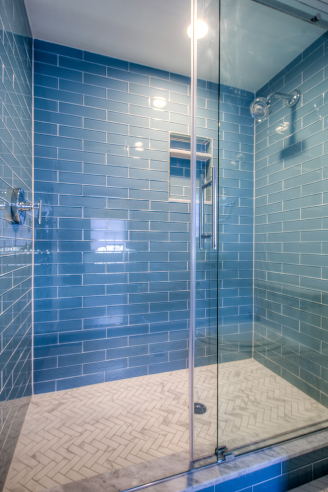 Ejemplo de cuarto de baño actual de tamaño medio con ducha empotrada, baldosas y/o azulejos azules, baldosas y/o azulejos de vidrio, paredes blancas, suelo de mármol, aseo y ducha, lavabo tipo consola, encimera de cuarzo compacto, suelo blanco, ducha con puerta corredera y encimeras blancas