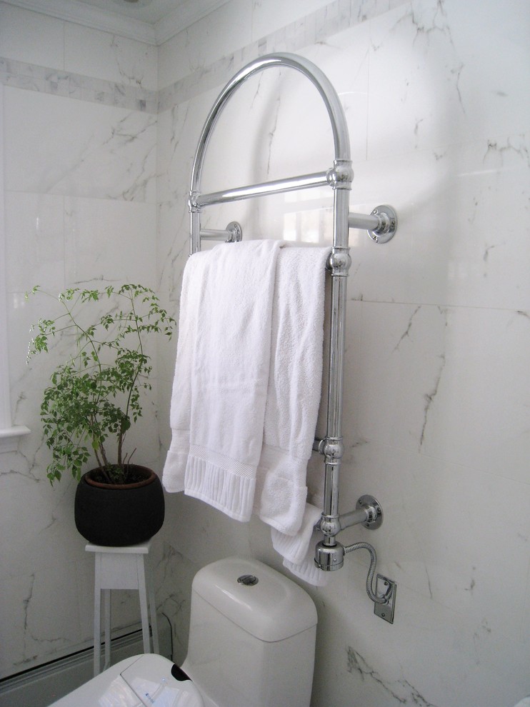 This is an example of a medium sized traditional ensuite bathroom with beaded cabinets, white cabinets, an alcove shower, a bidet, white tiles, stone tiles, white walls, marble flooring, a submerged sink and marble worktops.