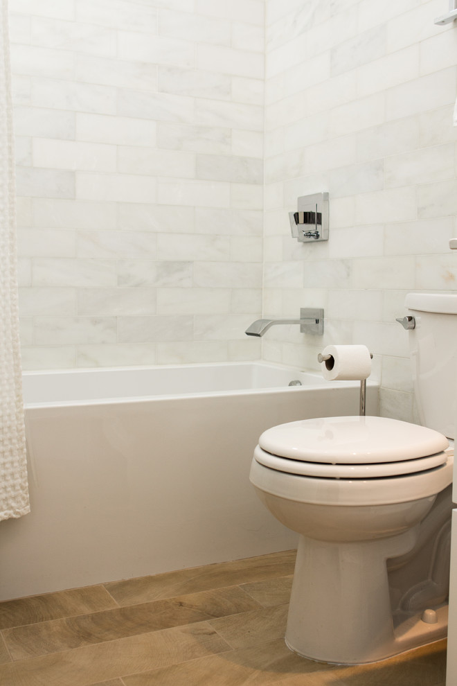 Design ideas for a modern bathroom in DC Metro with white tiles, stone tiles and porcelain flooring.