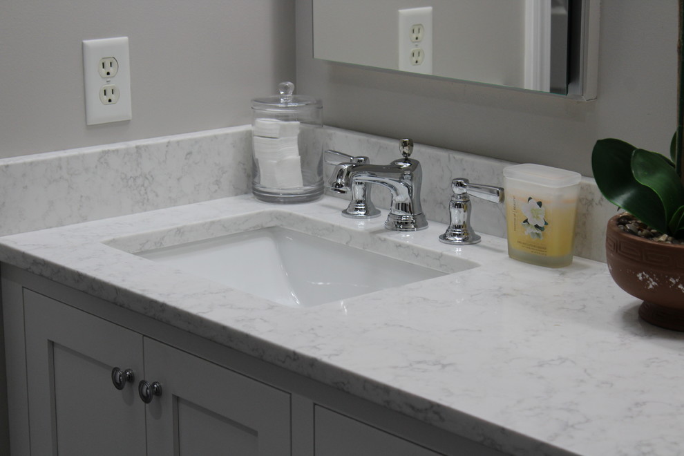 Exempel på ett mellanstort klassiskt badrum med dusch, med en kantlös dusch, en toalettstol med hel cisternkåpa, vit kakel, keramikplattor, grå väggar, ett undermonterad handfat, luckor med infälld panel, grå skåp, skiffergolv, marmorbänkskiva och grått golv