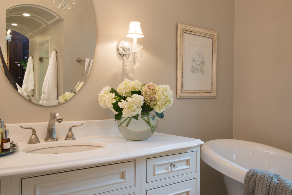 Inspiration for a large transitional master bathroom remodel in St Louis with beaded inset cabinets, white cabinets, white walls and an undermount sink
