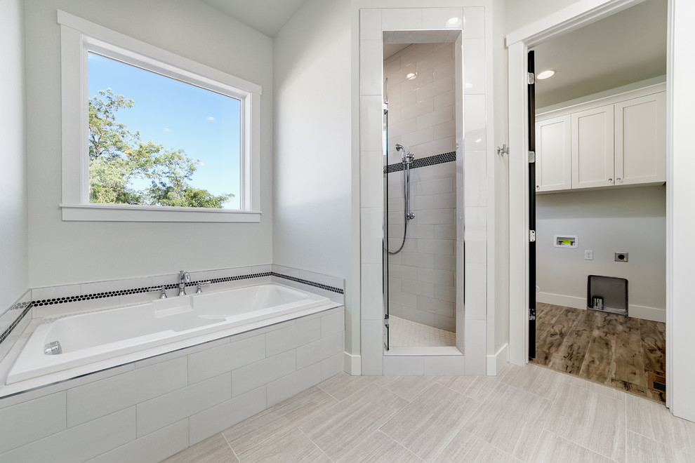 Bathroom - large farmhouse master gray tile and ceramic tile porcelain tile and gray floor bathroom idea in Boise with recessed-panel cabinets, black cabinets, a two-piece toilet, gray walls, an undermount sink, solid surface countertops, a hinged shower door and white countertops