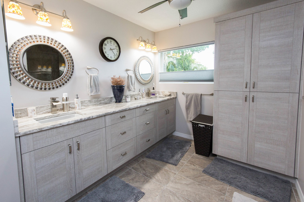 Photo of a medium sized contemporary ensuite bathroom in Miami with distressed cabinets, a walk-in shower, a one-piece toilet, brown tiles, porcelain tiles, grey walls, porcelain flooring, a submerged sink, engineered stone worktops and flat-panel cabinets.