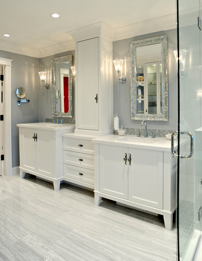 Example of a mid-sized classic master mosaic tile and white tile marble floor freestanding bathtub design in Vancouver with recessed-panel cabinets, white cabinets, quartz countertops, blue walls and an undermount sink