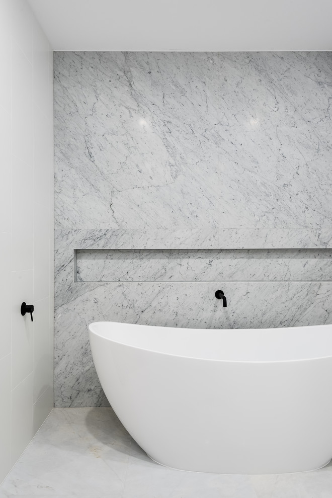 Inspiration for a medium sized modern ensuite bathroom in Brisbane with beaded cabinets, light wood cabinets, a freestanding bath, white tiles, porcelain tiles, marble flooring, quartz worktops, an open shower and white worktops.