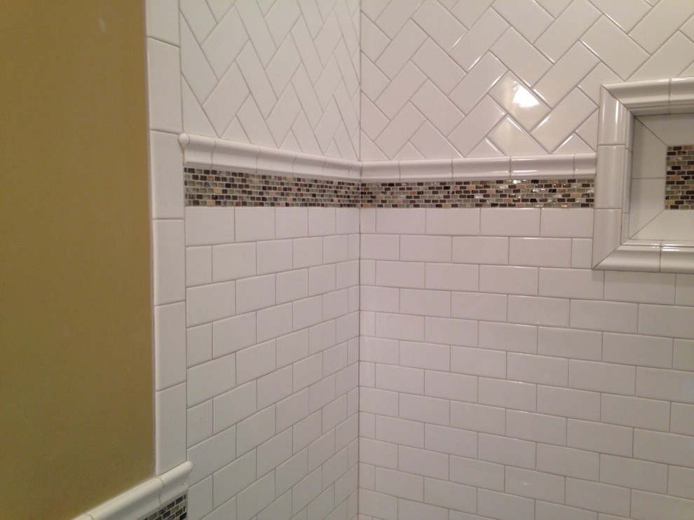 Klassisk inredning av ett mellanstort badrum med dusch, med ett badkar med tassar, en öppen dusch, stickkakel, grå väggar, klinkergolv i keramik och bänkskiva i kvartsit