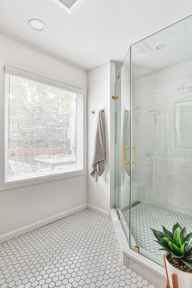 Corner shower - mid-sized mid-century modern master white tile and subway tile mosaic tile floor and white floor corner shower idea in New York with beaded inset cabinets, a two-piece toilet, white walls, a drop-in sink, a hinged shower door and white countertops