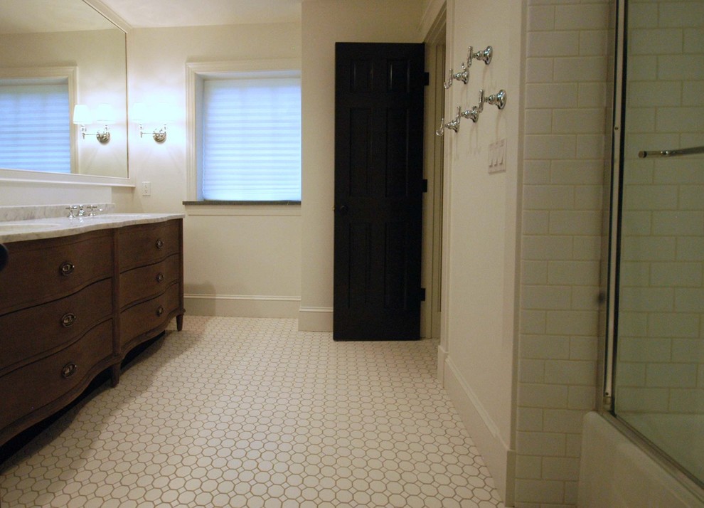 Classic ensuite bathroom in Other with dark wood cabinets, a freestanding bath, a corner shower, white tiles, grey walls and ceramic flooring.
