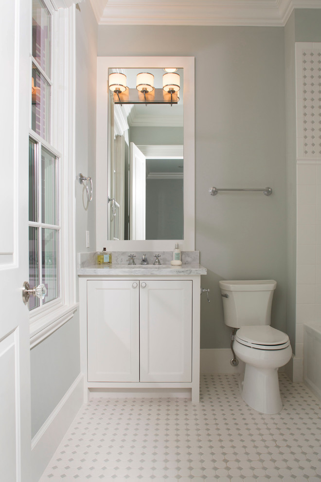 Inspiration for an expansive traditional cloakroom in Houston with shaker cabinets, white cabinets, grey walls, ceramic flooring, marble worktops, multi-coloured floors, grey worktops and a built in vanity unit.