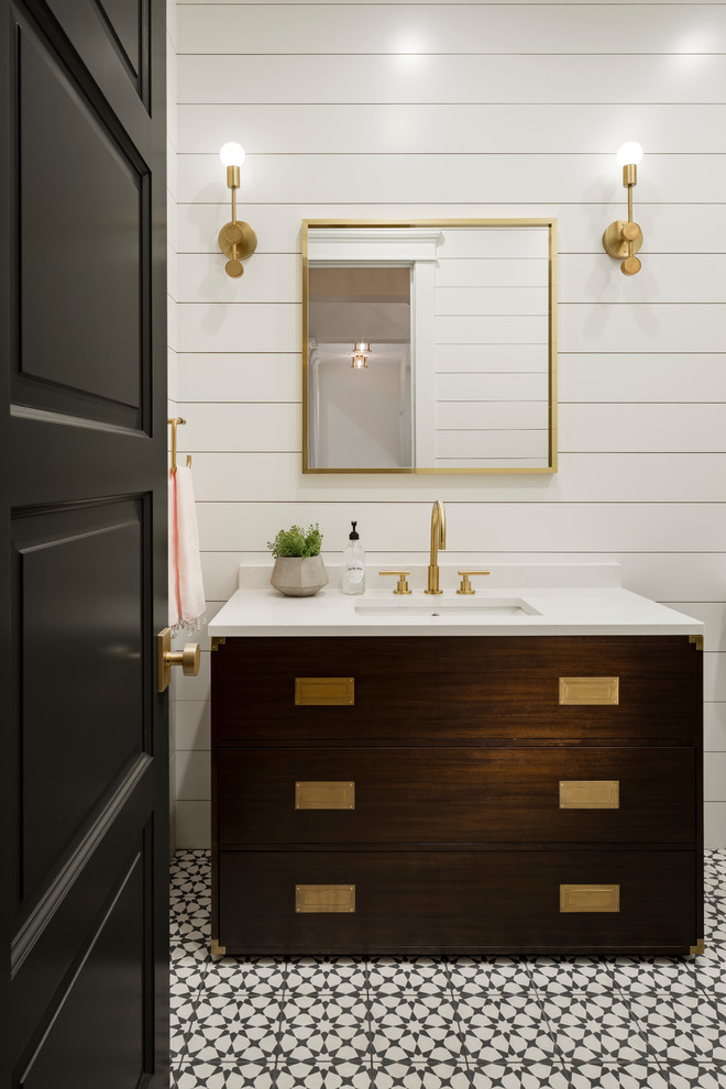 Inspiration for a large traditional shower room bathroom in Phoenix with recessed-panel cabinets, brown cabinets, a walk-in shower, a one-piece toilet, white tiles, white walls, cement flooring, a submerged sink, engineered stone worktops and black floors.