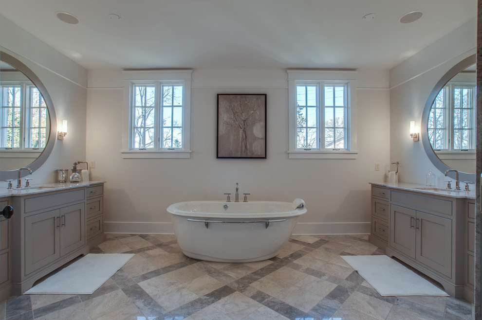 Bathroom - large transitional master gray tile and stone tile limestone floor and multicolored floor bathroom idea in Nashville with an undermount sink, furniture-like cabinets, distressed cabinets, granite countertops, a two-piece toilet, beige walls, white countertops and a hinged shower door