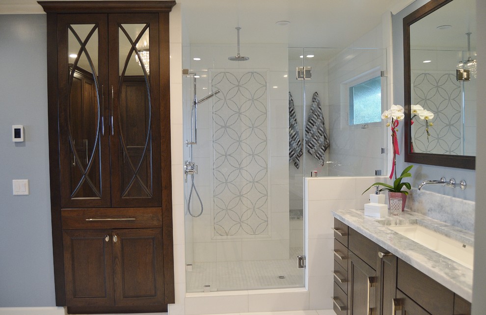 Inspiration for a large transitional master white tile and stone tile marble floor alcove shower remodel in San Francisco with recessed-panel cabinets, dark wood cabinets, a trough sink, granite countertops and gray walls