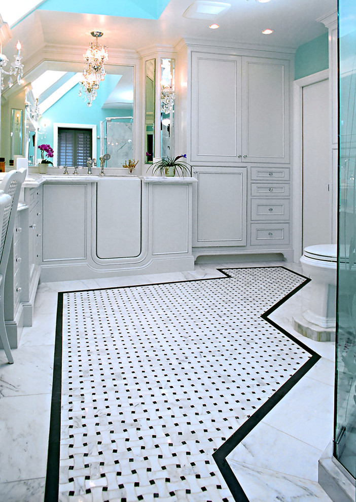 Large classic bathroom in Los Angeles with a built-in sink, beaded cabinets, white cabinets, marble worktops, a freestanding bath, a corner shower, a one-piece toilet, white tiles, mosaic tiles and marble flooring.