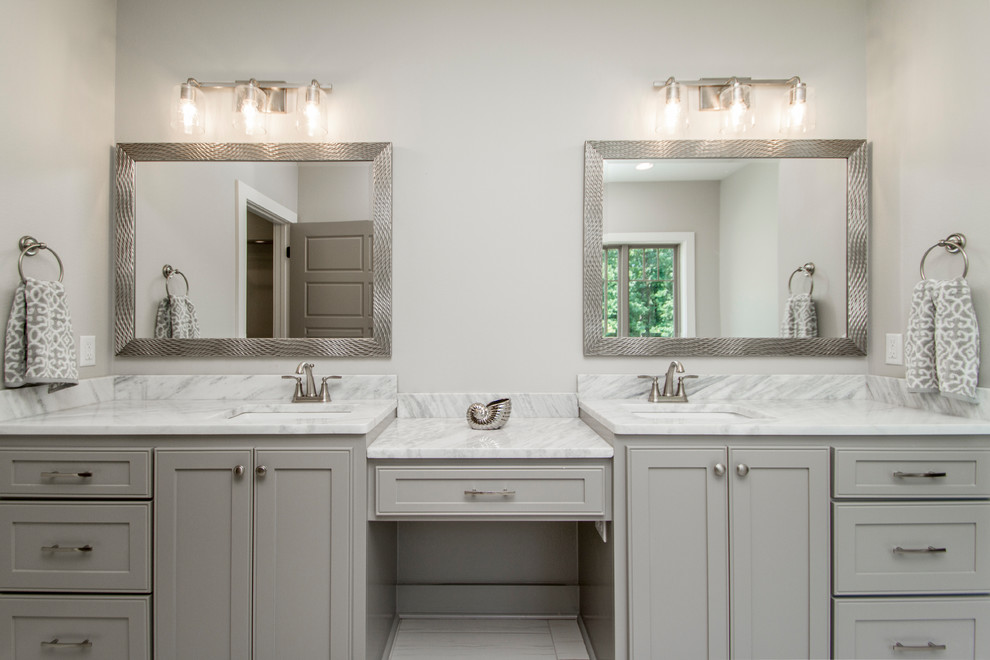 Large traditional ensuite bathroom in Little Rock with recessed-panel cabinets, grey cabinets, a freestanding bath, a corner shower, a two-piece toilet, grey tiles, porcelain tiles, grey walls, porcelain flooring, a submerged sink, marble worktops, grey floors, an open shower and white worktops.