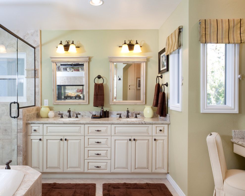 This is an example of a medium sized traditional ensuite bathroom in San Diego with raised-panel cabinets, white cabinets, solid surface worktops, a submerged sink, a built-in bath, a corner shower, porcelain tiles, beige walls, ceramic flooring, beige floors, a hinged door and feature lighting.