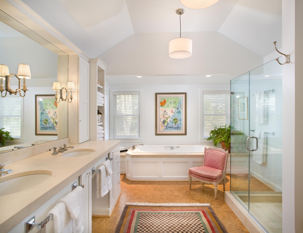 Cette image montre une salle de bain traditionnelle avec un lavabo encastré, des portes de placard blanches, une baignoire posée, une douche d'angle, un carrelage beige et un mur blanc.