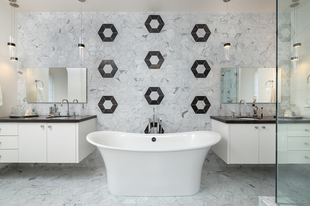 Example of a mid-sized trendy master gray tile and marble tile marble floor and gray floor freestanding bathtub design in Los Angeles with recessed-panel cabinets, white cabinets, quartzite countertops, gray walls and an undermount sink