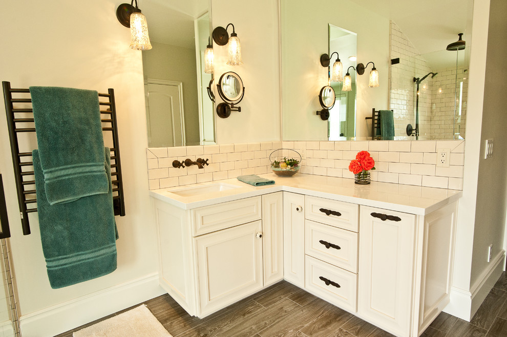 Example of a large beach style master multicolored tile and stone tile ceramic tile bathroom design in Orange County with raised-panel cabinets, white cabinets, beige walls, an undermount sink and quartz countertops