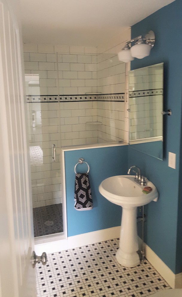 Example of a mid-sized beach style 3/4 black and white tile porcelain tile bathroom design in Boston with a one-piece toilet, blue walls and a pedestal sink