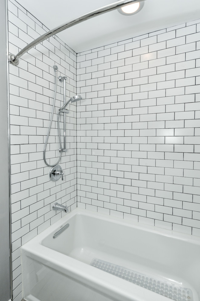 Medium sized classic shower room bathroom in DC Metro with recessed-panel cabinets, white cabinets, an alcove bath, a shower/bath combination, a two-piece toilet, white tiles, grey walls, medium hardwood flooring, a built-in sink, engineered stone worktops, brown floors, a hinged door and white worktops.