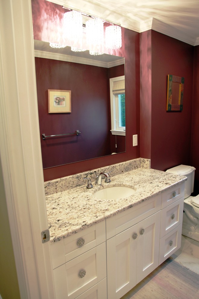 Photo of a medium sized classic shower room bathroom in Boston with shaker cabinets, white cabinets, an alcove bath, a shower/bath combination, a two-piece toilet, red walls, light hardwood flooring, a submerged sink and engineered stone worktops.