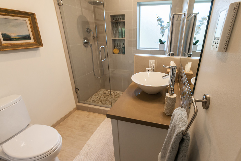 Design ideas for a small contemporary ensuite bathroom in Other with flat-panel cabinets, white cabinets, an alcove shower, a two-piece toilet, blue tiles, glass sheet walls, white walls, porcelain flooring, a vessel sink and engineered stone worktops.