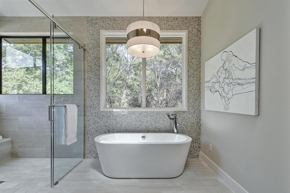 Large transitional master gray tile porcelain tile bathroom photo in Austin with flat-panel cabinets, medium tone wood cabinets, a one-piece toilet, gray walls, an undermount sink and solid surface countertops