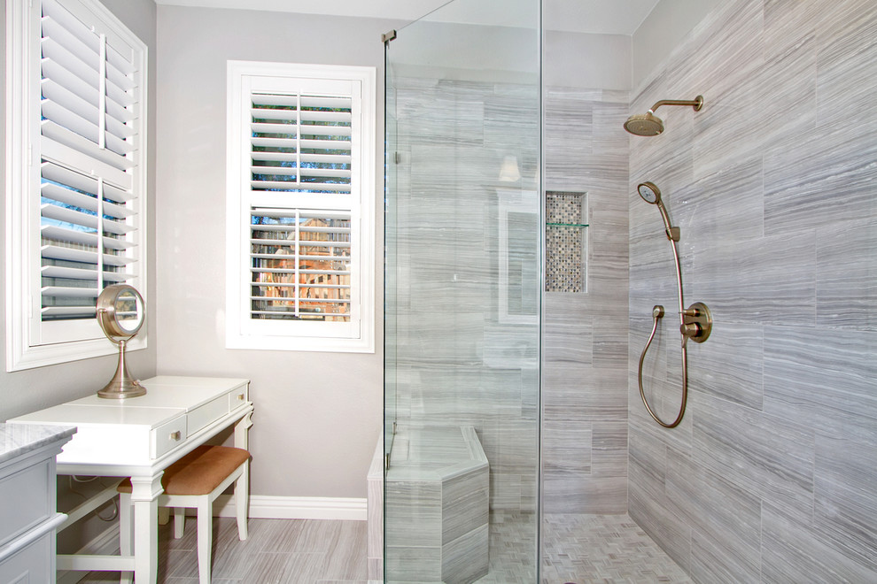 Photo of a large traditional ensuite bathroom in Los Angeles with recessed-panel cabinets, white cabinets, a corner shower, a two-piece toilet, grey tiles, porcelain tiles, white walls, porcelain flooring, a built-in sink, quartz worktops, a hinged door, grey worktops, double sinks and a built in vanity unit.