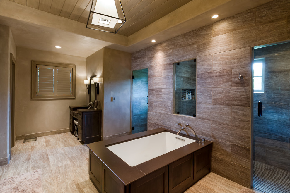 Photo of a large classic wet room bathroom in St Louis with brown cabinets and a submerged bath.