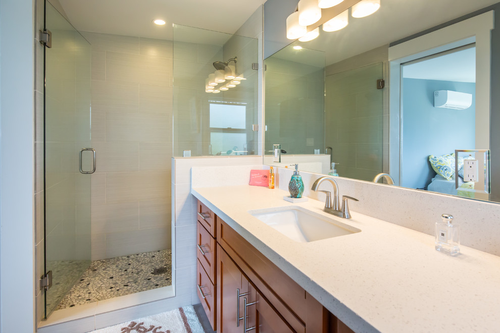 Alcove shower - mid-sized transitional master gray tile and porcelain tile alcove shower idea in Hawaii with shaker cabinets, medium tone wood cabinets, blue walls, an undermount sink and quartz countertops