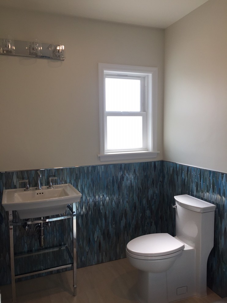 Mid-sized beach style 3/4 blue tile and glass tile porcelain tile corner shower photo in Los Angeles with a one-piece toilet, beige walls and a console sink