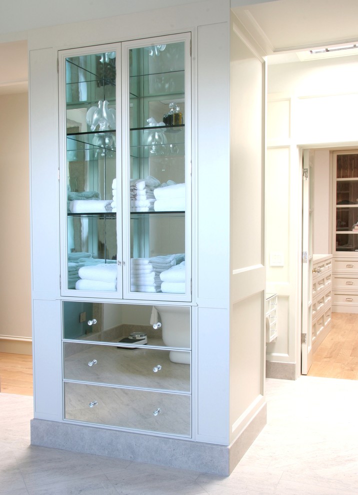 This is an example of a classic bathroom in Los Angeles with glass-front cabinets.