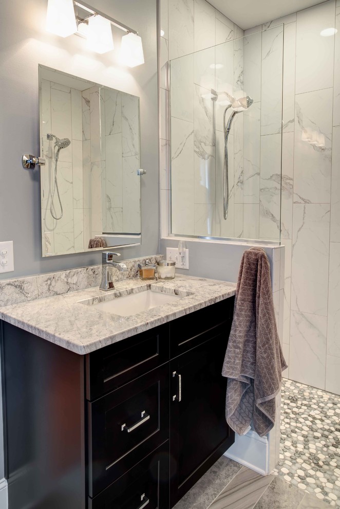 Photo of a small classic ensuite bathroom in Raleigh with shaker cabinets, dark wood cabinets, a built-in shower, white tiles, porcelain tiles, grey walls, porcelain flooring, a submerged sink, granite worktops, grey floors and an open shower.