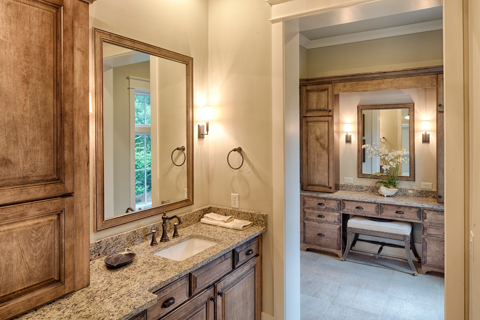 Example of a large classic master beige tile and subway tile slate floor bathroom design in Charleston with an undermount sink, beaded inset cabinets, medium tone wood cabinets, granite countertops, a one-piece toilet and beige walls