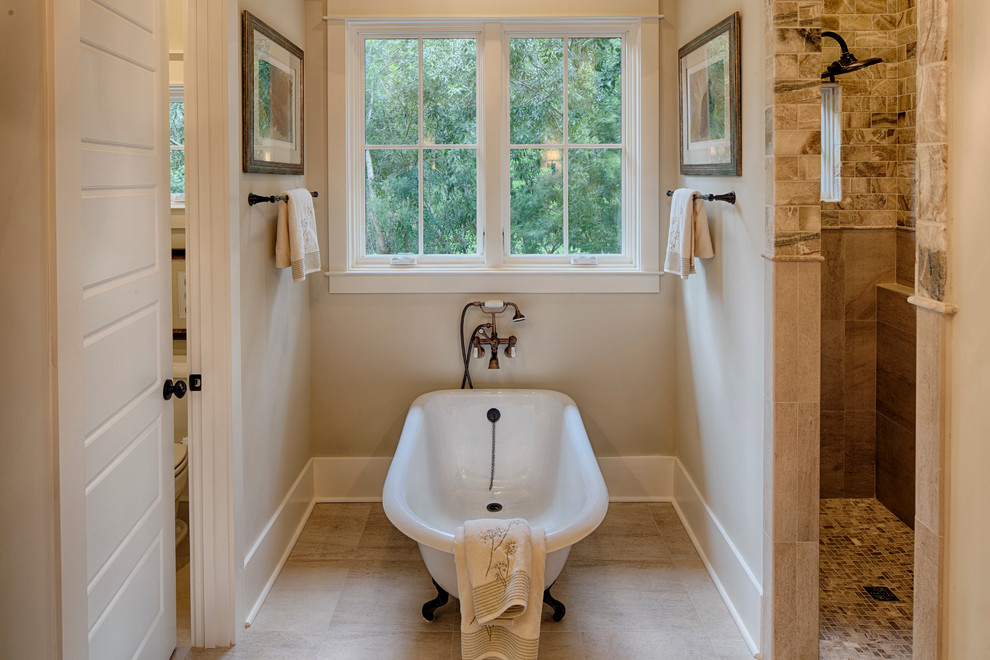 Inspiration for a large timeless master beige tile and subway tile slate floor bathroom remodel in Charleston with an undermount sink, beaded inset cabinets, medium tone wood cabinets, granite countertops, a one-piece toilet and beige walls