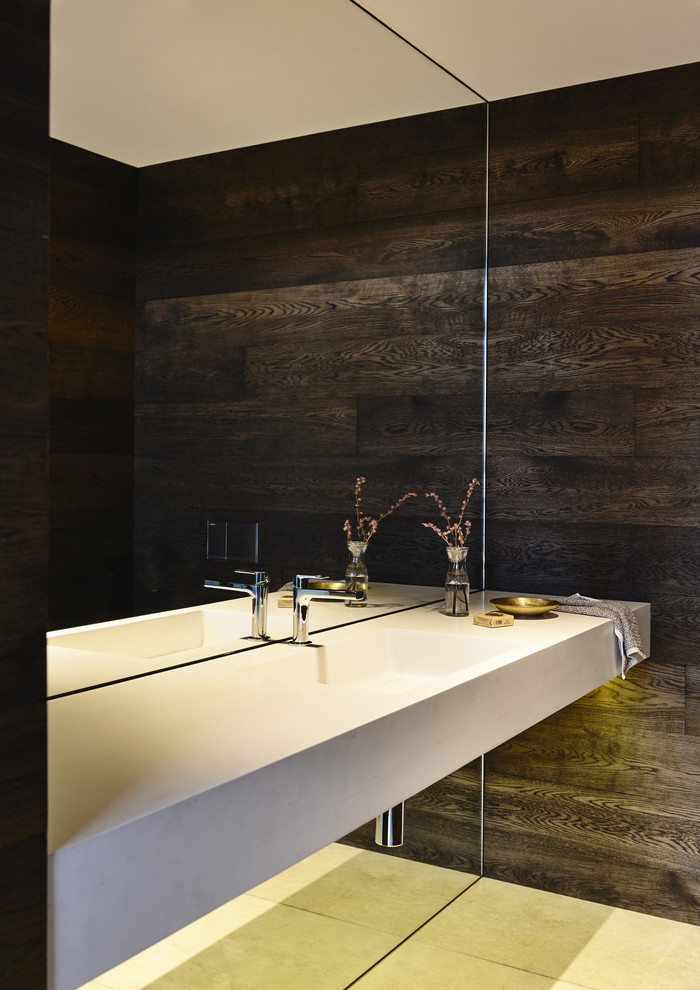Photo of a contemporary bathroom in Melbourne with limestone flooring and a wall-mounted sink.
