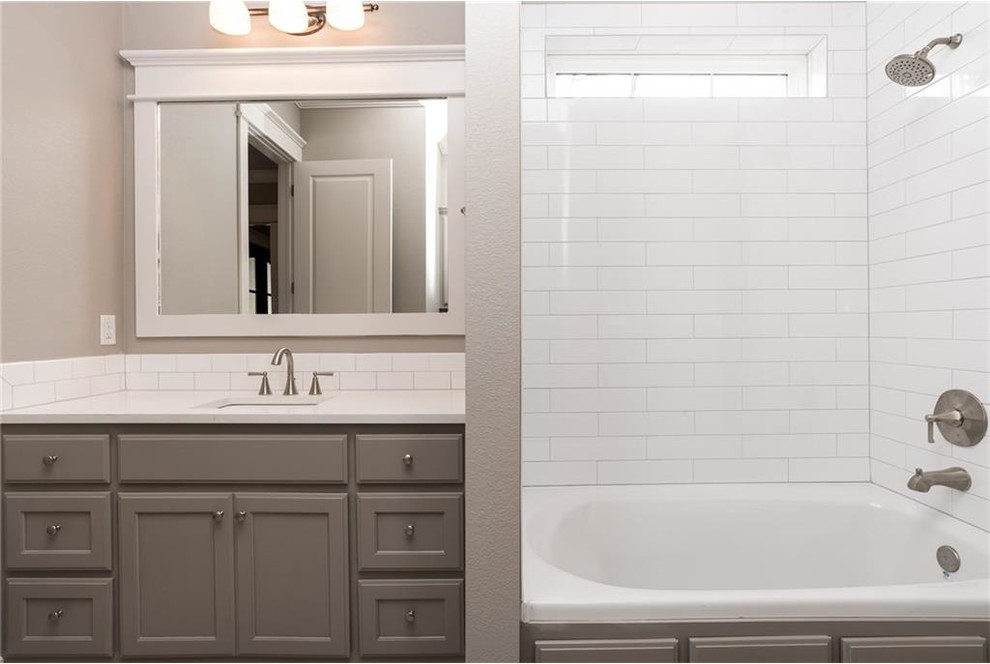 На фото: ванная комната в стиле неоклассика (современная классика) с фасадами с утопленной филенкой, серыми фасадами, накладной ванной, душем над ванной, белой плиткой, керамической плиткой, серыми стенами, полом из керамогранита, врезной раковиной и столешницей из искусственного кварца с