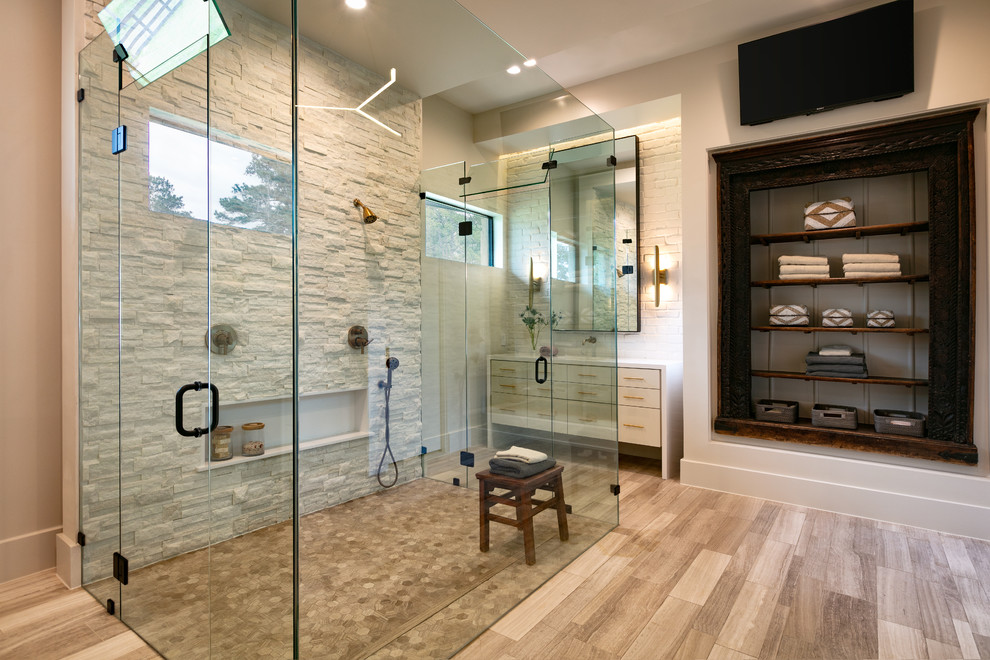 Inspiration for a medium sized modern ensuite bathroom with shaker cabinets, white cabinets, a built-in shower, a one-piece toilet, stone tiles, beige walls, light hardwood flooring, a submerged sink, brown floors, a hinged door and white worktops.