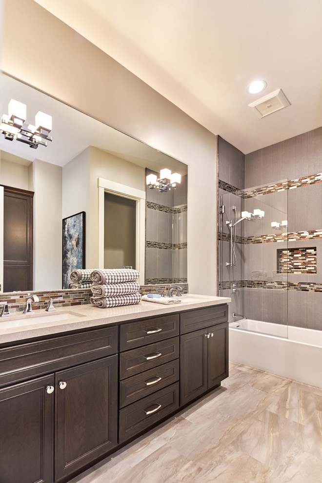Inspiration for a large classic family bathroom in San Francisco with recessed-panel cabinets, dark wood cabinets, an alcove bath, a two-piece toilet, grey tiles, porcelain tiles, grey walls, porcelain flooring, a submerged sink and engineered stone worktops.