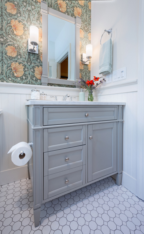 Small classic bathroom in Sacramento with shaker cabinets, grey cabinets, an alcove bath, a shower/bath combination, a two-piece toilet, white tiles, ceramic tiles, ceramic flooring, a submerged sink, marble worktops, white floors, a shower curtain, white worktops, a single sink, a freestanding vanity unit and wallpapered walls.