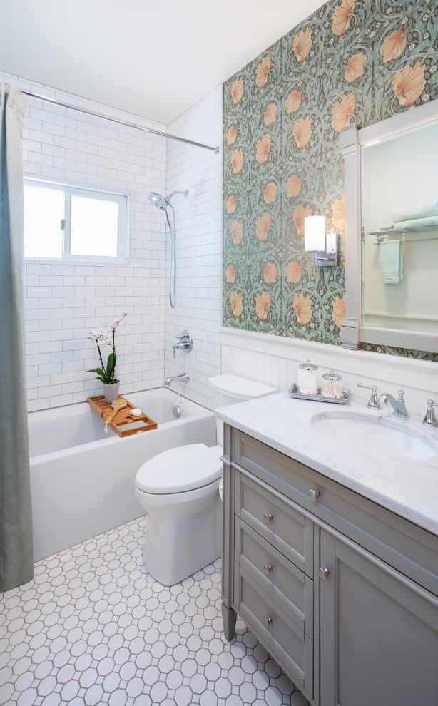 Small classic bathroom in Sacramento with shaker cabinets, grey cabinets, an alcove bath, a shower/bath combination, a two-piece toilet, white tiles, ceramic tiles, ceramic flooring, a submerged sink, marble worktops, white floors, a shower curtain, white worktops, a single sink, a freestanding vanity unit and wallpapered walls.