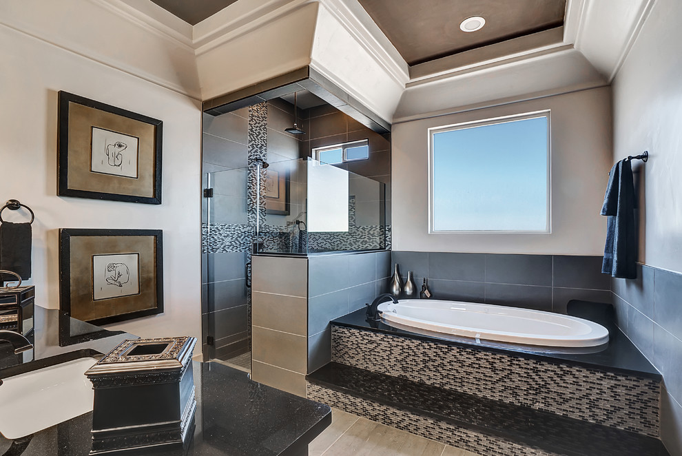 This is an example of a medium sized traditional ensuite bathroom in Austin with raised-panel cabinets, dark wood cabinets, a built-in bath, a corner shower, black and white tiles, multi-coloured tiles, matchstick tiles, white walls, ceramic flooring, a submerged sink and granite worktops.