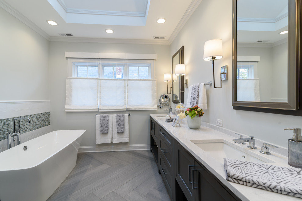 Inspiration for a large transitional master white tile and subway tile porcelain tile and gray floor bathroom remodel in Chicago with furniture-like cabinets, gray cabinets, a two-piece toilet, gray walls, an undermount sink, quartz countertops and a hinged shower door
