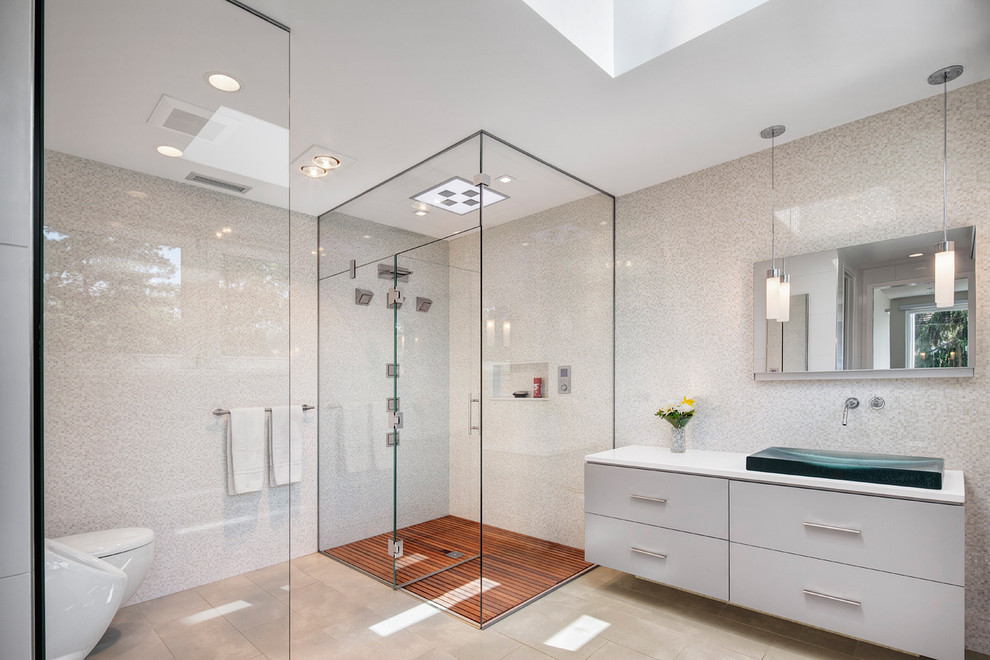Trendy master white tile and mosaic tile corner shower photo in Chicago with a vessel sink, flat-panel cabinets, white cabinets, a one-piece toilet, white walls, solid surface countertops and a hinged shower door